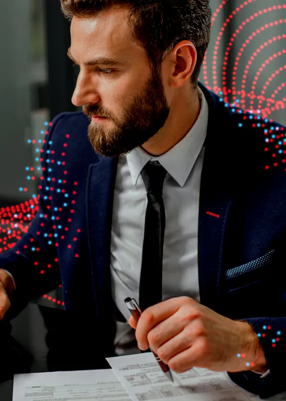 Man reading from a laptop and taking notes